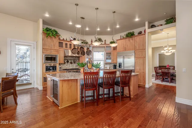 a kitchen with stainless steel appliances granite countertop a stove and cabinets