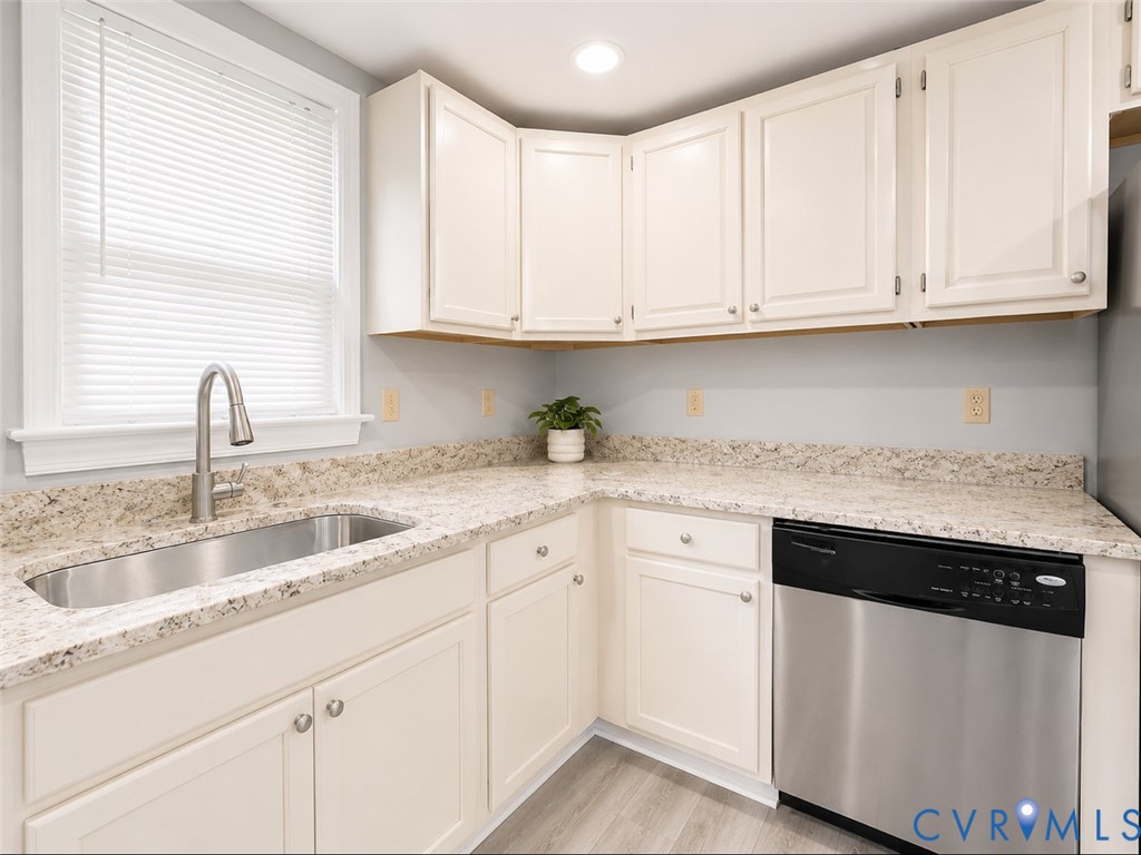110 Locust Grove Cartersville, VA 23027 - Photo 19 of 26 a kitchen with granite countertop white cabinets and white appliances