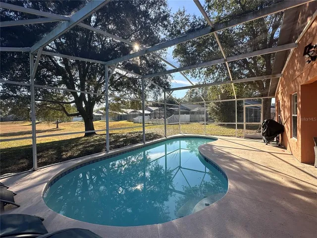 a view of a swimming pool with a patio