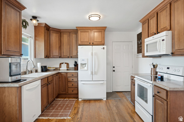 495 North 250 West Springville, UT 84663 - Photo 6 of 35 Kitchen featuring white appliances, wood finish cabinets, light countertops, and light wood finished floors