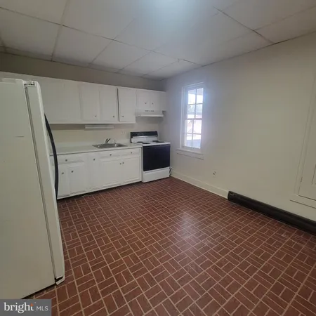a kitchen with a cabinets and window
