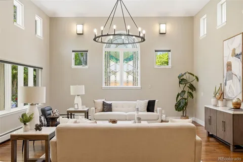 a living room with furniture a chandelier and a table