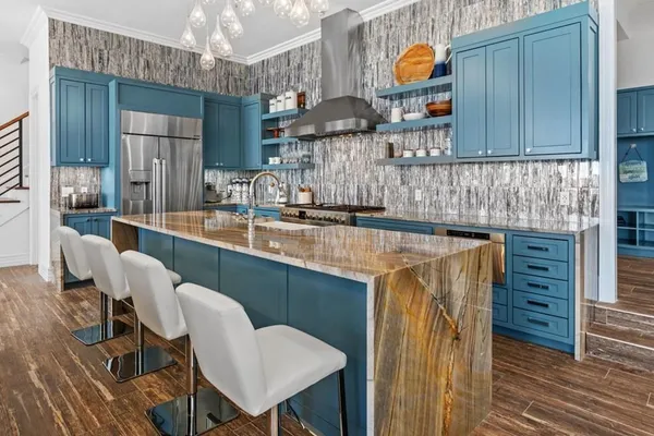 a large kitchen with a table and chairs