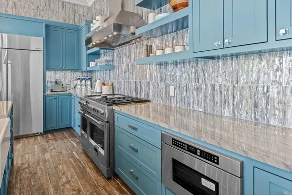 a kitchen with stainless steel appliances granite countertop a stove and a refrigerator