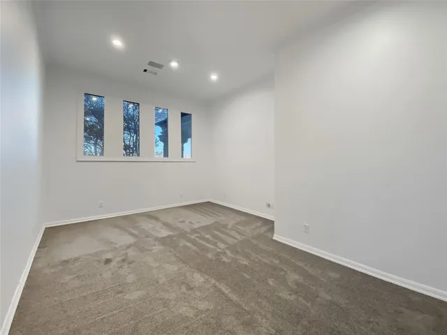 a lobby with furniture and large windows