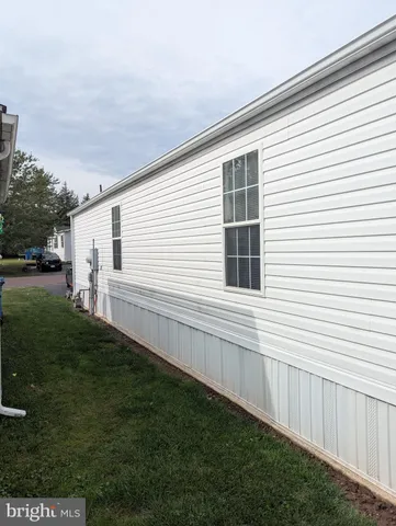 a view of backyard with barbeque grill and wooden fence
