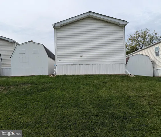 a view of a house with backyard and deck