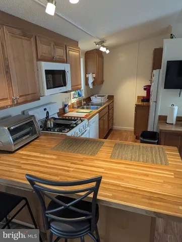 a kitchen with stainless steel appliances kitchen island granite countertop a sink and cabinets
