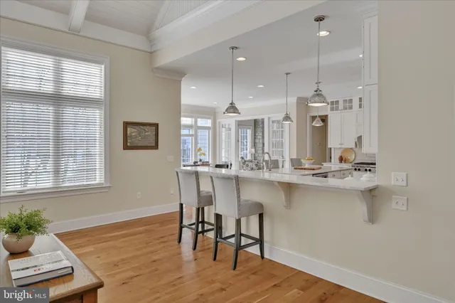 a kitchen with stainless steel appliances granite countertop a refrigerator a oven a sink and white cabinets