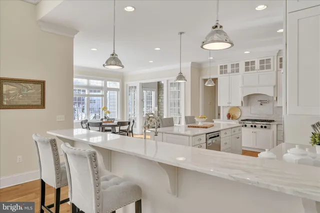 a kitchen with white cabinets and appliances