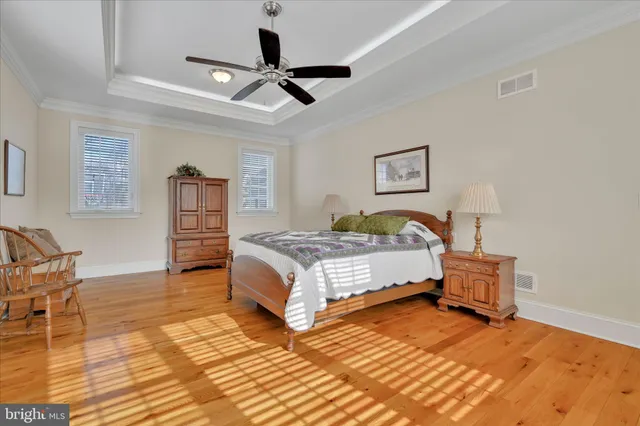 a bedroom with furniture and a large window