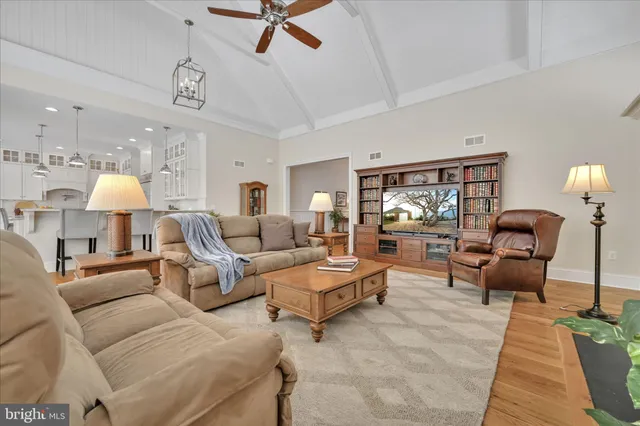 a large kitchen with granite countertop a stove a sink a dining table and chairs