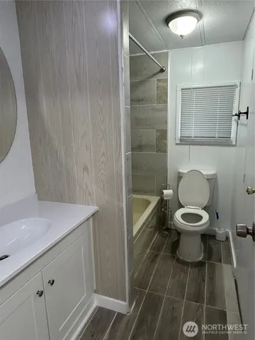 a white toilet sitting next to a bathroom sink