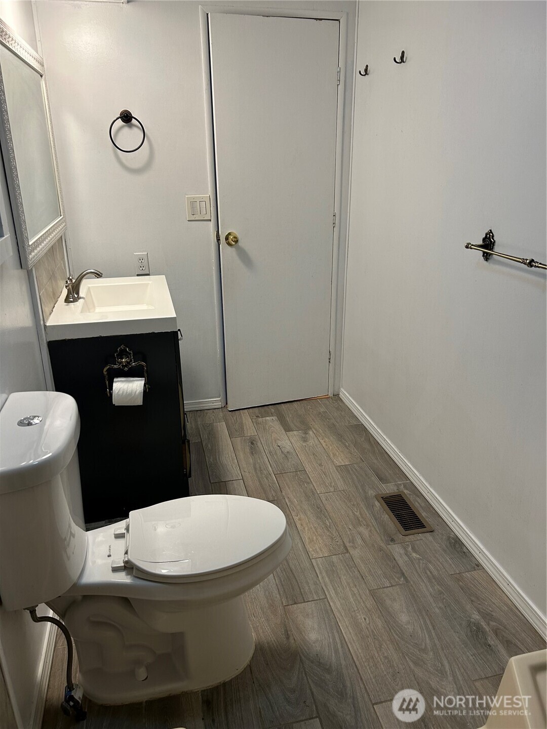 13101 64th Avenue South Seattle, WA 98178 - Photo 23 of 34 a white toilet sitting next to a bathroom sink