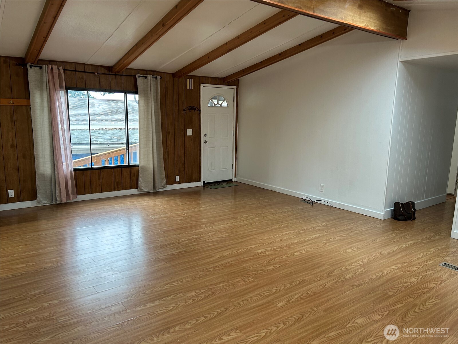 13101 64th Avenue South Seattle, WA 98178 - Photo 8 of 34 an empty room with wooden floor and windows