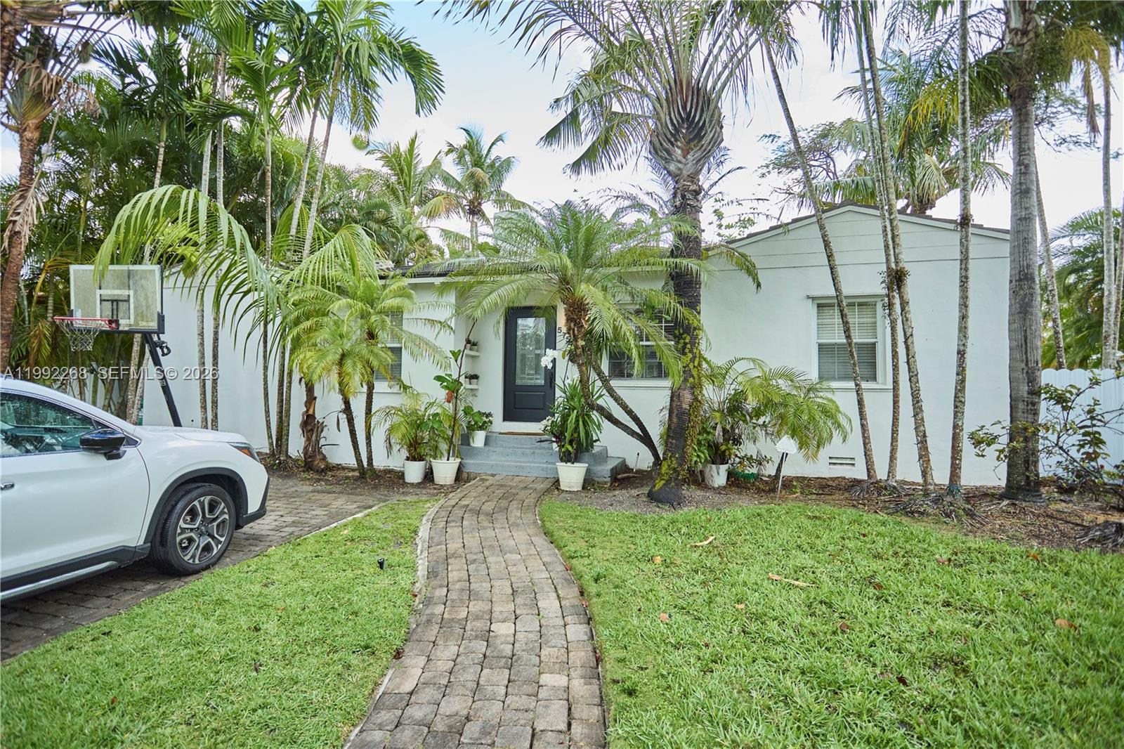 5755 Devonshire Boulevard, Unit 5755 Miami, FL 33155 - Photo 1 of 30 a front view of a house with a garden