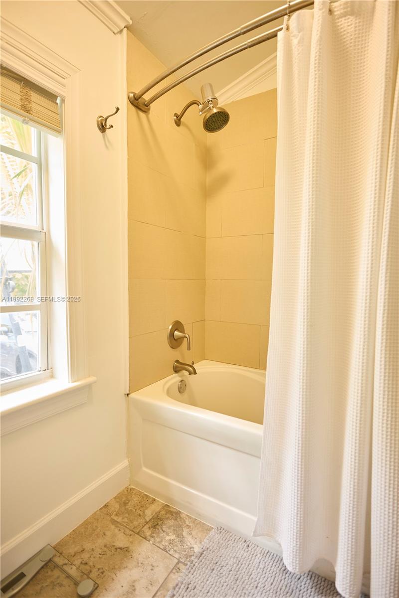 5755 Devonshire Boulevard, Unit 5755 Miami, FL 33155 - Photo 21 of 30 a bath tub sitting next to a white sink and a shower