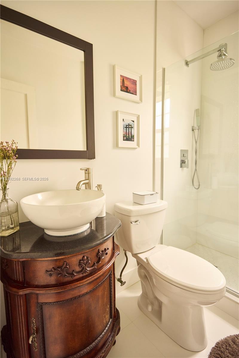 5755 Devonshire Boulevard, Unit 5755 Miami, FL 33155 - Photo 25 of 30 a bathroom with a sink and a mirror