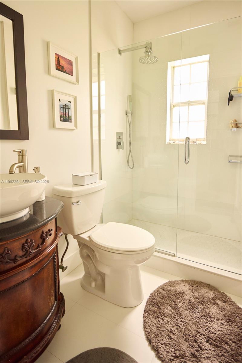 5755 Devonshire Boulevard, Unit 5755 Miami, FL 33155 - Photo 26 of 30 a bathroom with a sink a toilet and shower