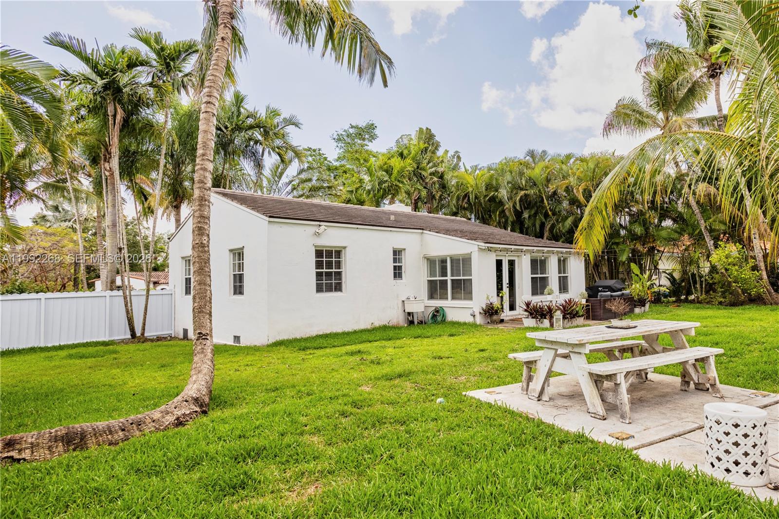 5755 Devonshire Boulevard, Unit 5755 Miami, FL 33155 - Photo 29 of 30 a view of a house with a yard and sitting area