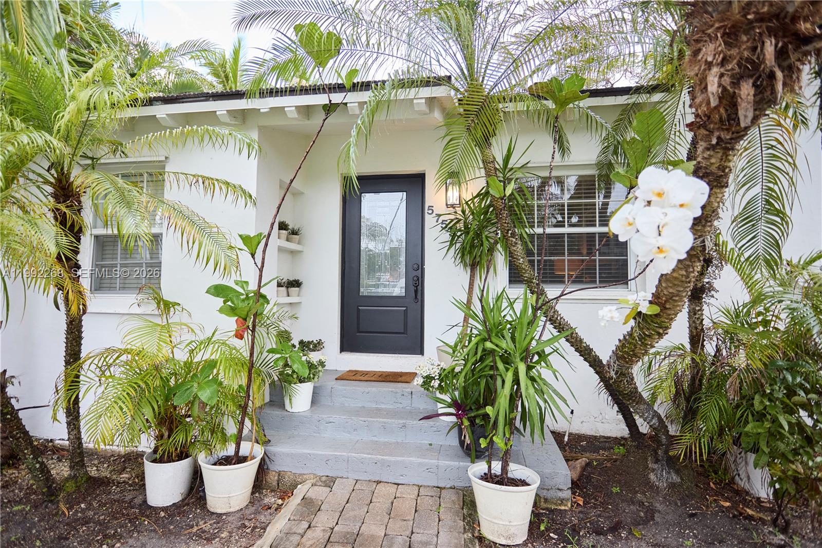 5755 Devonshire Boulevard, Unit 5755 Miami, FL 33155 - Photo 3 of 30 a potted plant in front of a building