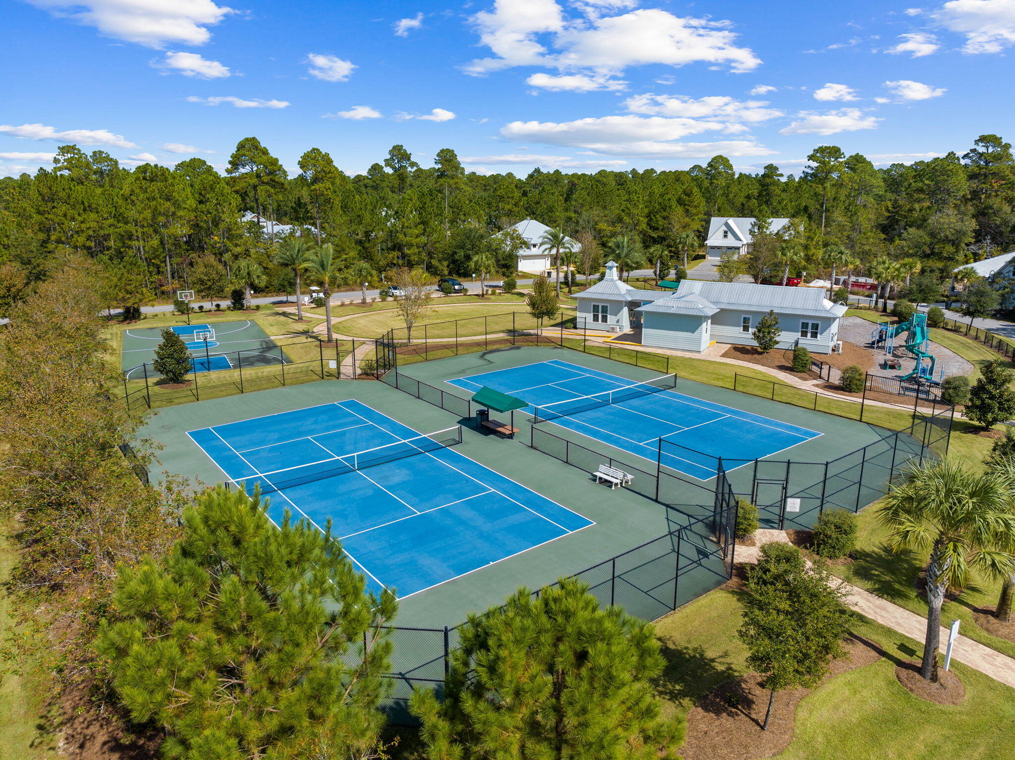 Lot 11 Sun Bear Circle Freeport, FL 32439 - Photo 20 of 28 a view of a swimming pool with lawn chairs under an umbrella