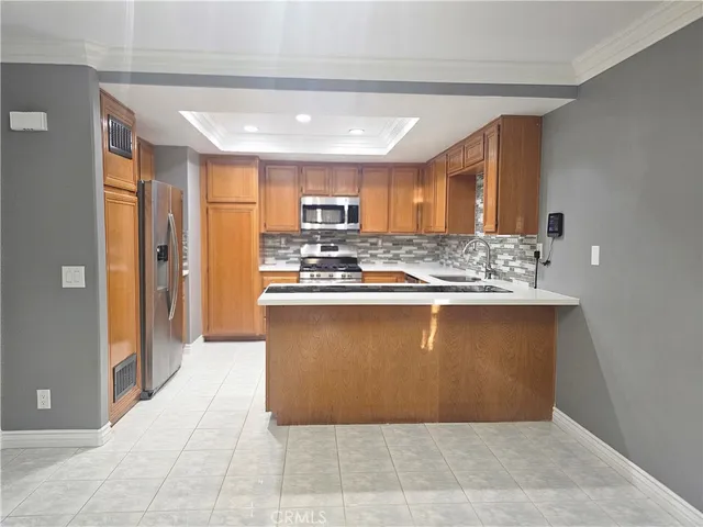 a view of kitchen appliances and cabinets