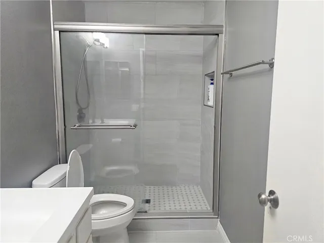a white toilet sitting next to a bathroom sink