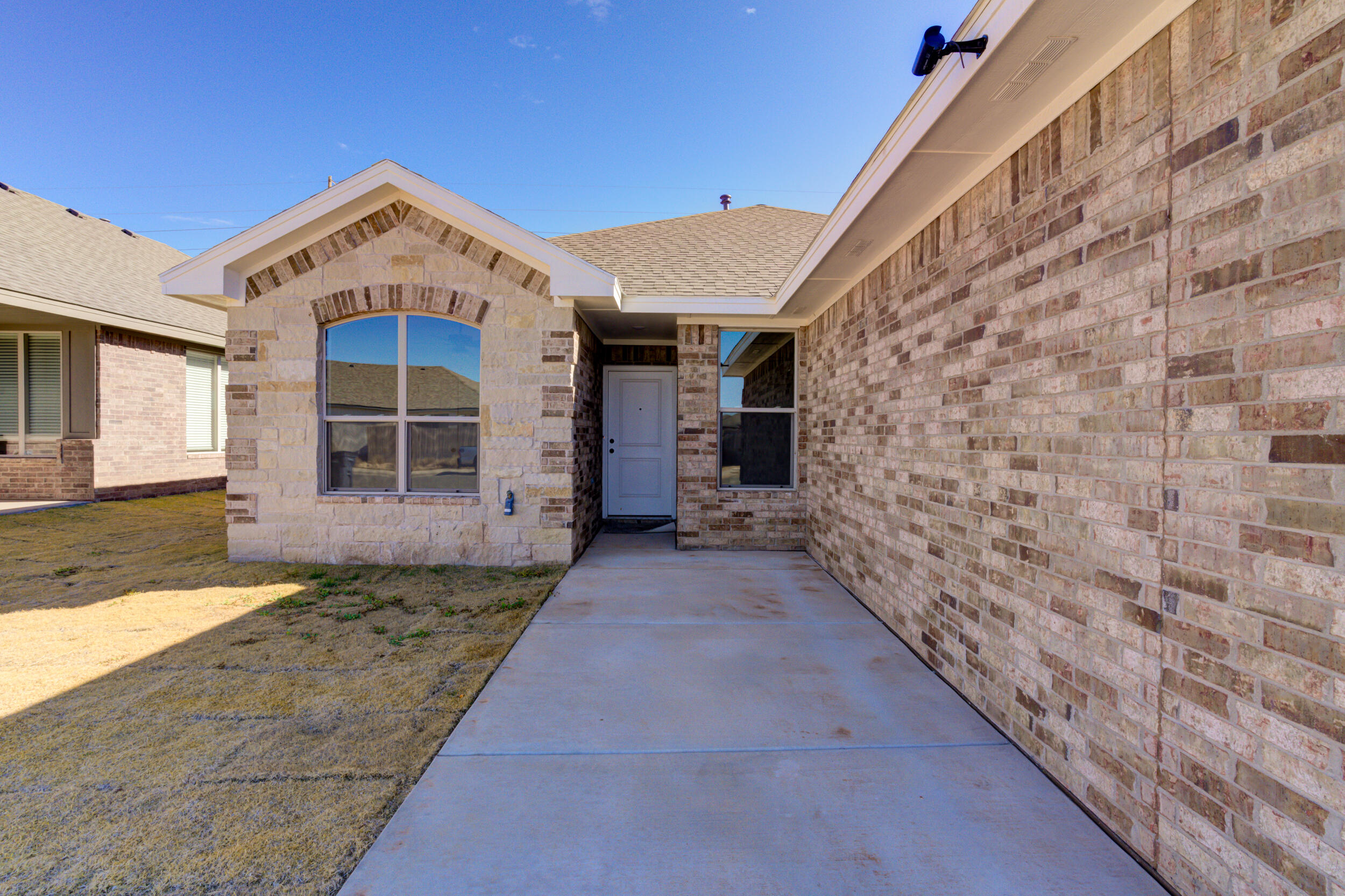 1005 Quincy Avenue Lubbock, TX 79416 - Photo 1 of 46 a view of a brick house with large windows