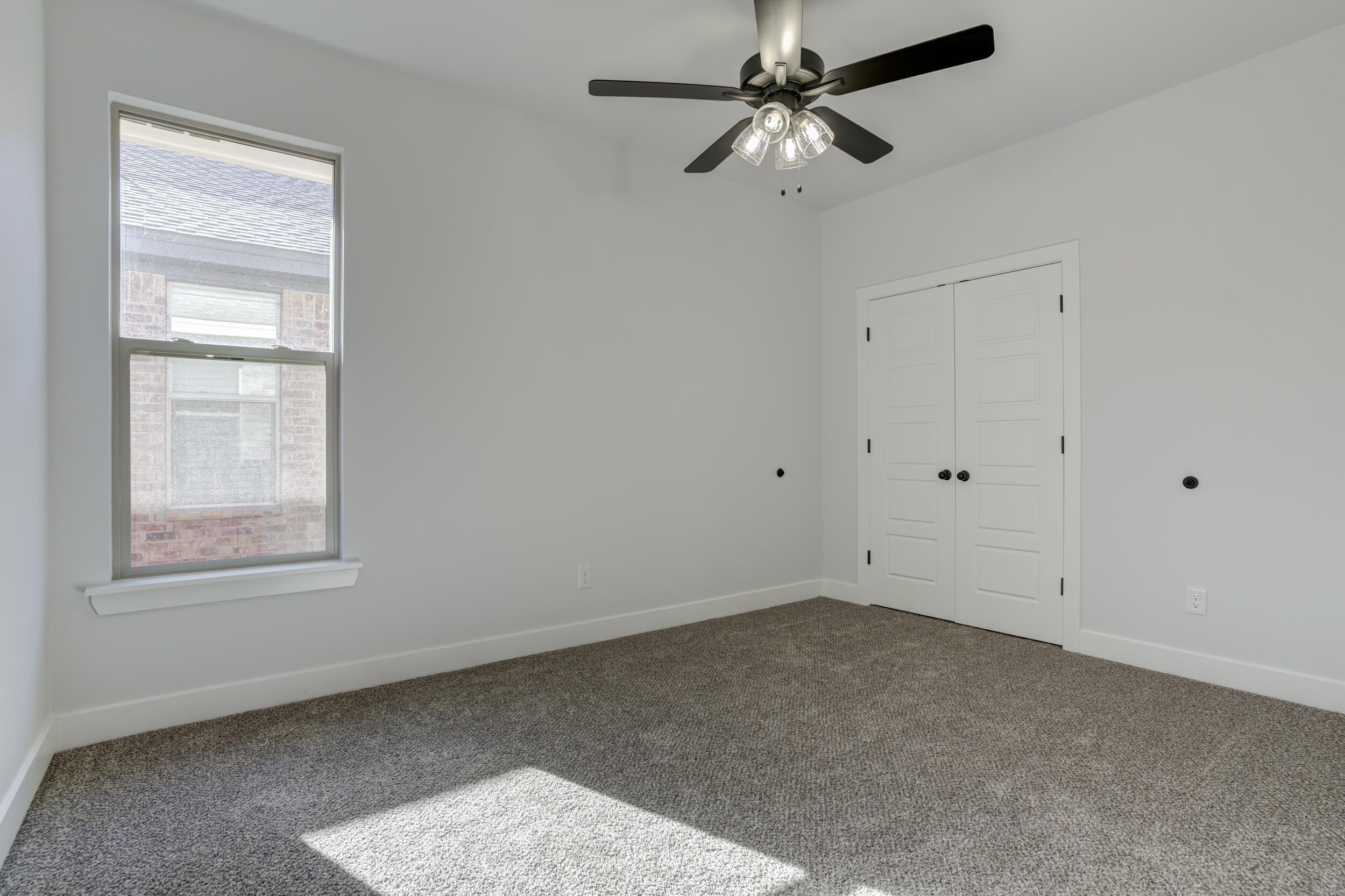 1005 Quincy Avenue Lubbock, TX 79416 - Photo 11 of 46 an empty room with windows and fan