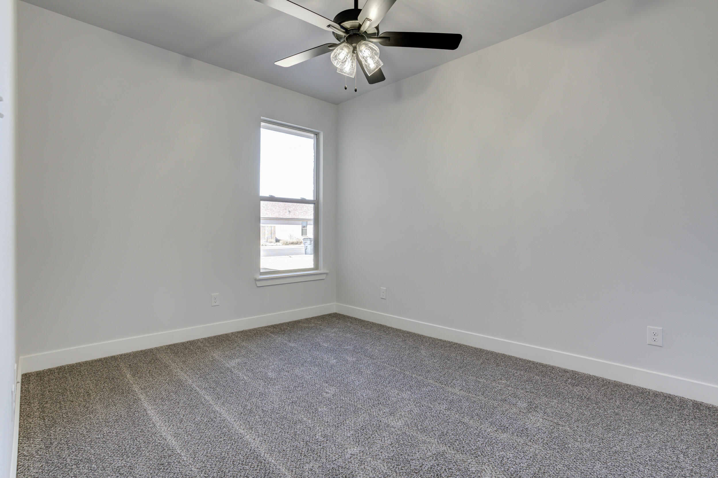1005 Quincy Avenue Lubbock, TX 79416 - Photo 14 of 46 an empty room with a window and a fan