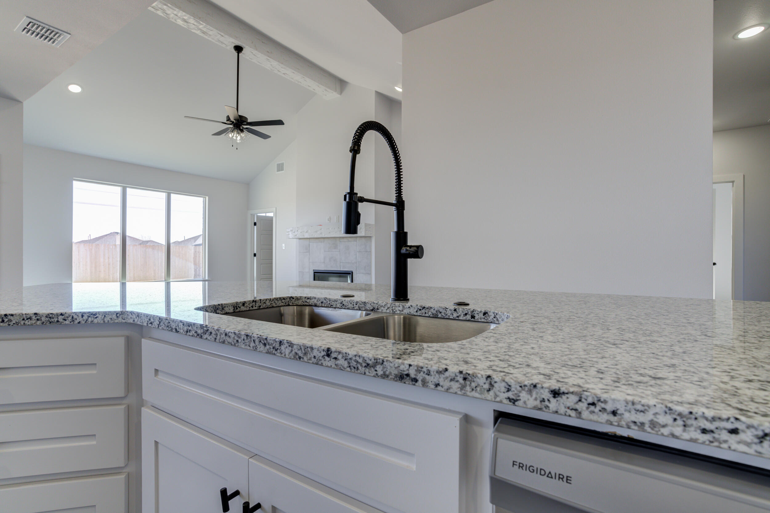 1005 Quincy Avenue Lubbock, TX 79416 - Photo 19 of 46 a kitchen with granite countertop a sink and a wooden floor