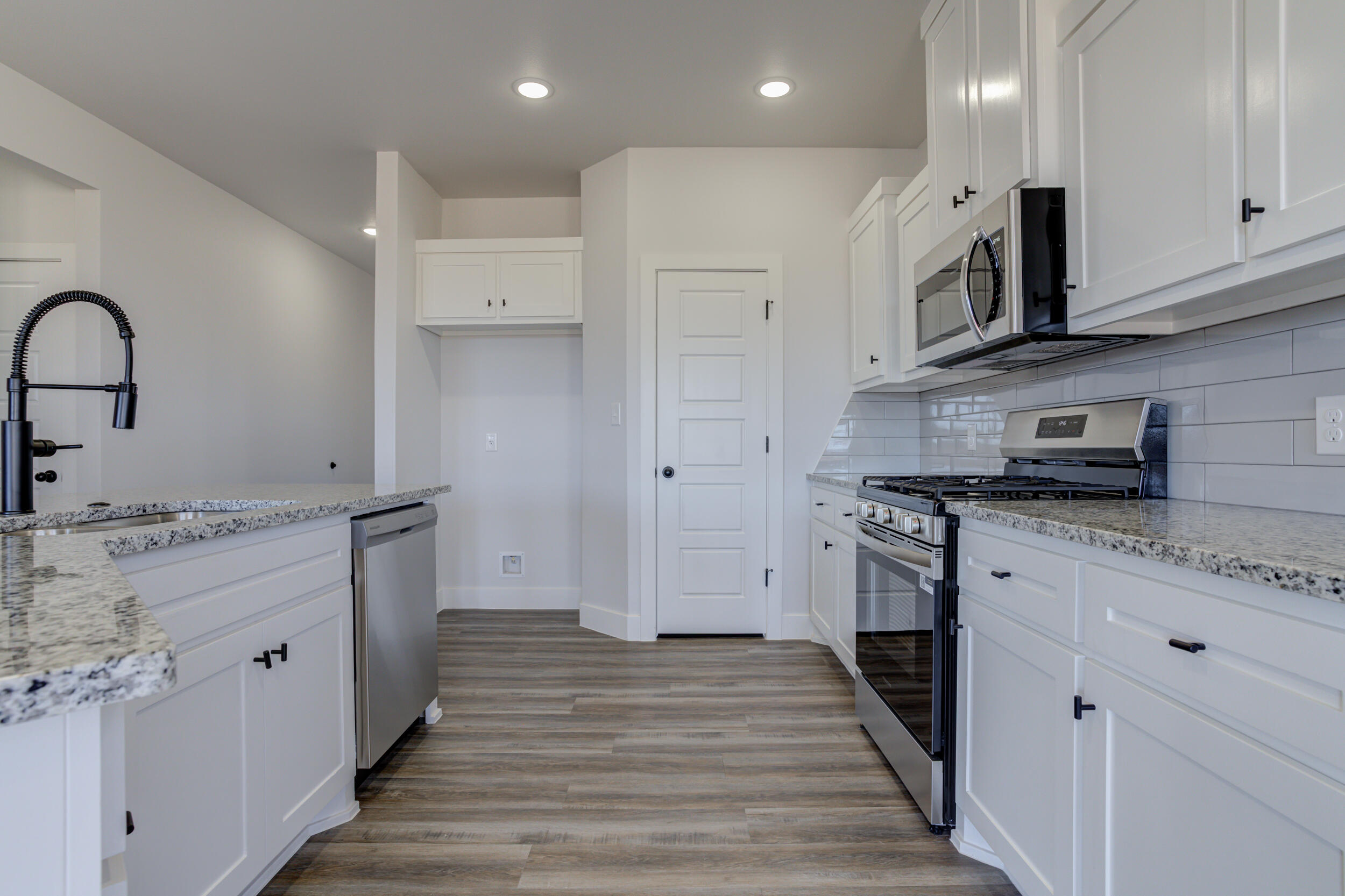 1005 Quincy Avenue Lubbock, TX 79416 - Photo 20 of 46 a kitchen with stainless steel appliances granite countertop a stove and a sink