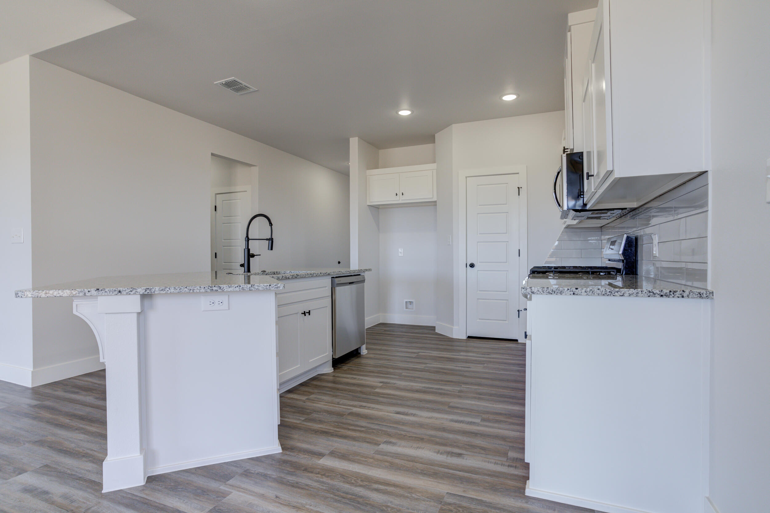 1005 Quincy Avenue Lubbock, TX 79416 - Photo 21 of 46 a kitchen with kitchen island sink stove and refrigerator