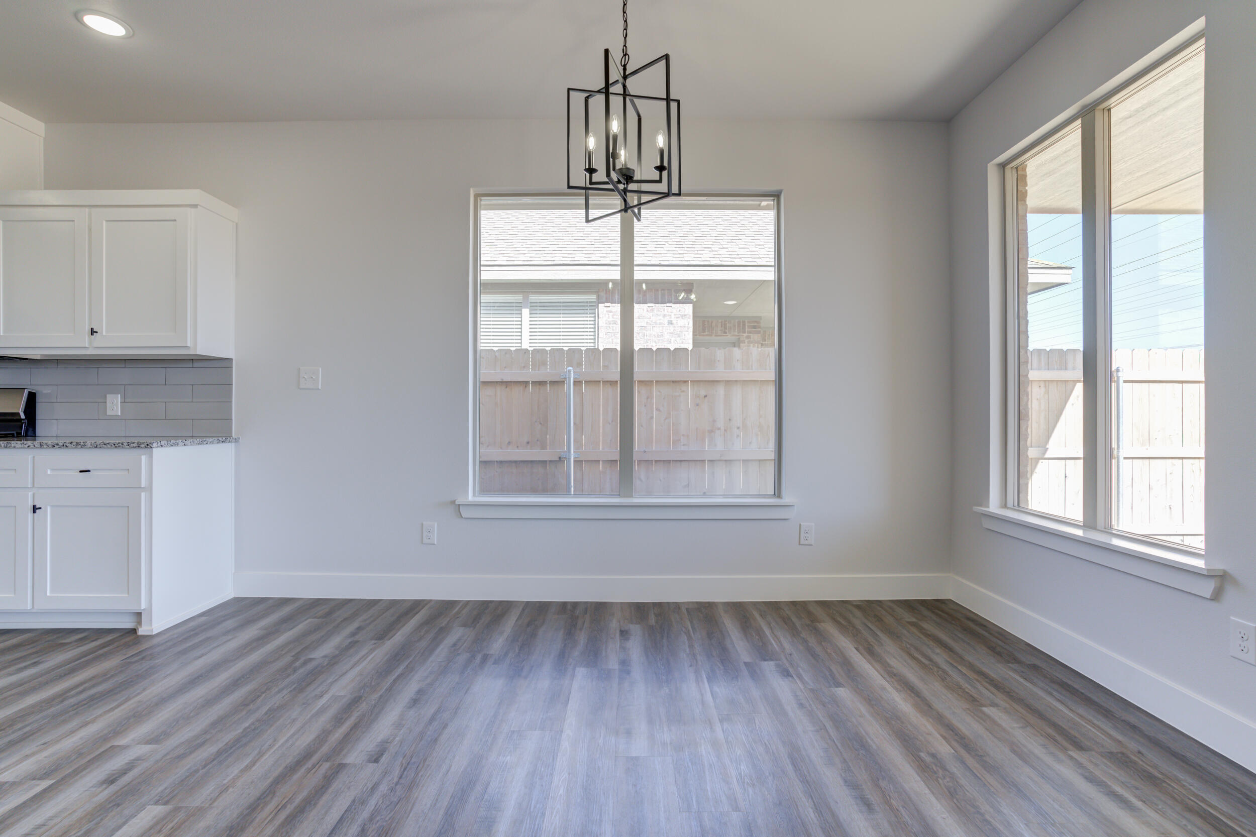 1005 Quincy Avenue Lubbock, TX 79416 - Photo 23 of 46 an empty room with wooden floor and windows