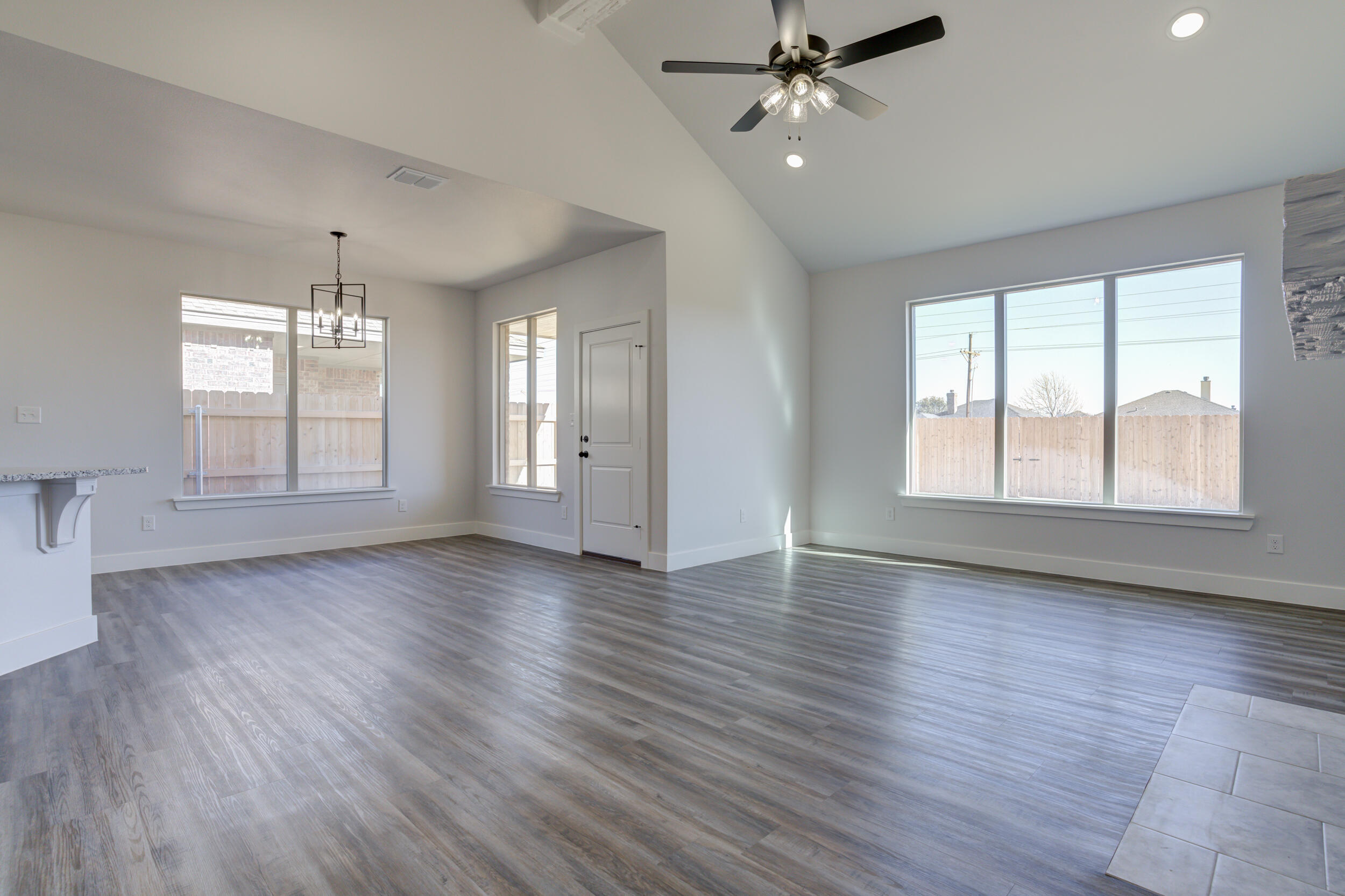 1005 Quincy Avenue Lubbock, TX 79416 - Photo 30 of 46 a view of an empty room with wooden floor and a window