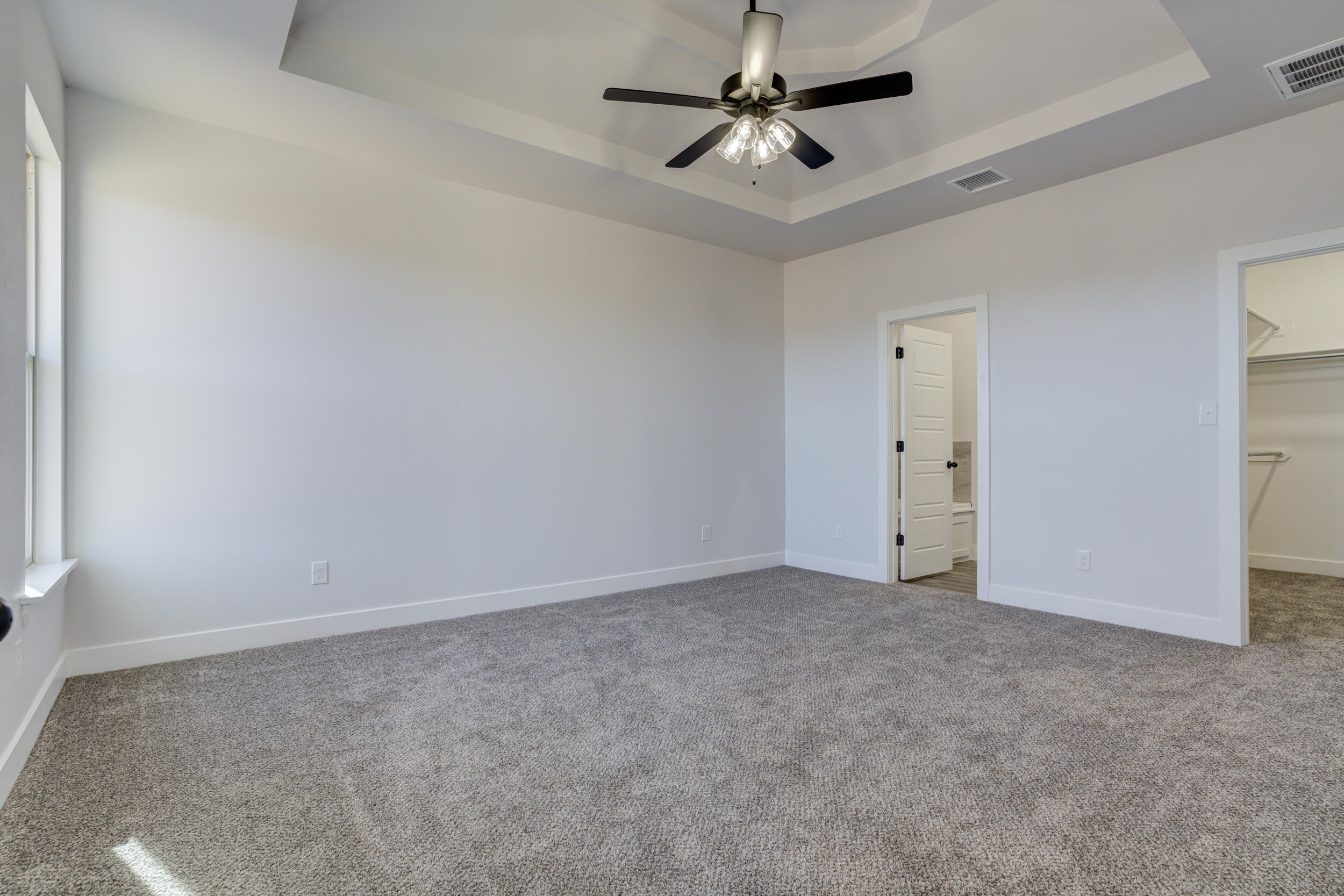 1005 Quincy Avenue Lubbock, TX 79416 - Photo 32 of 46 an empty room with a ceiling fan and carpet