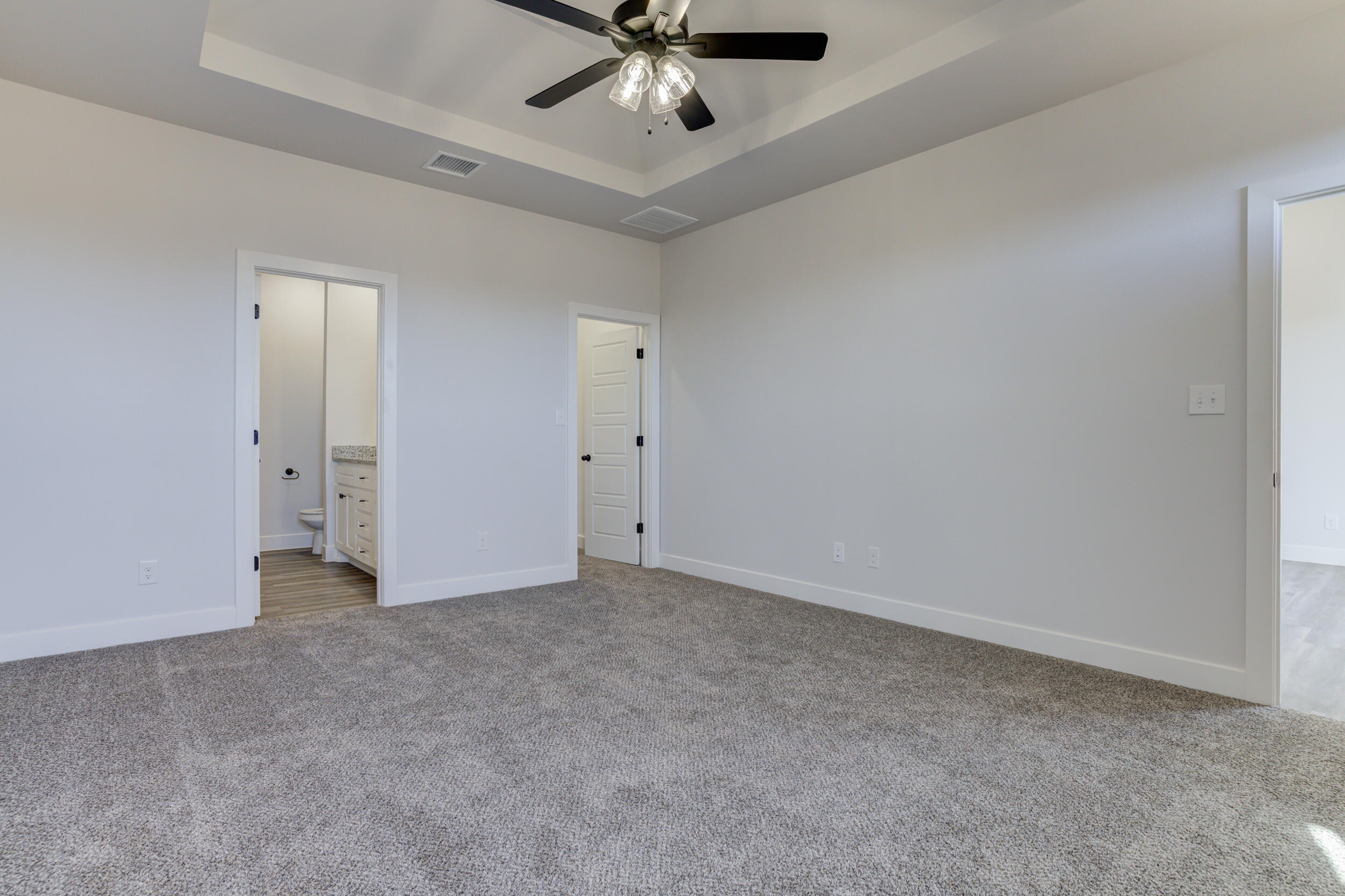 1005 Quincy Avenue Lubbock, TX 79416 - Photo 33 of 46 an empty room with a ceiling fan and carpet