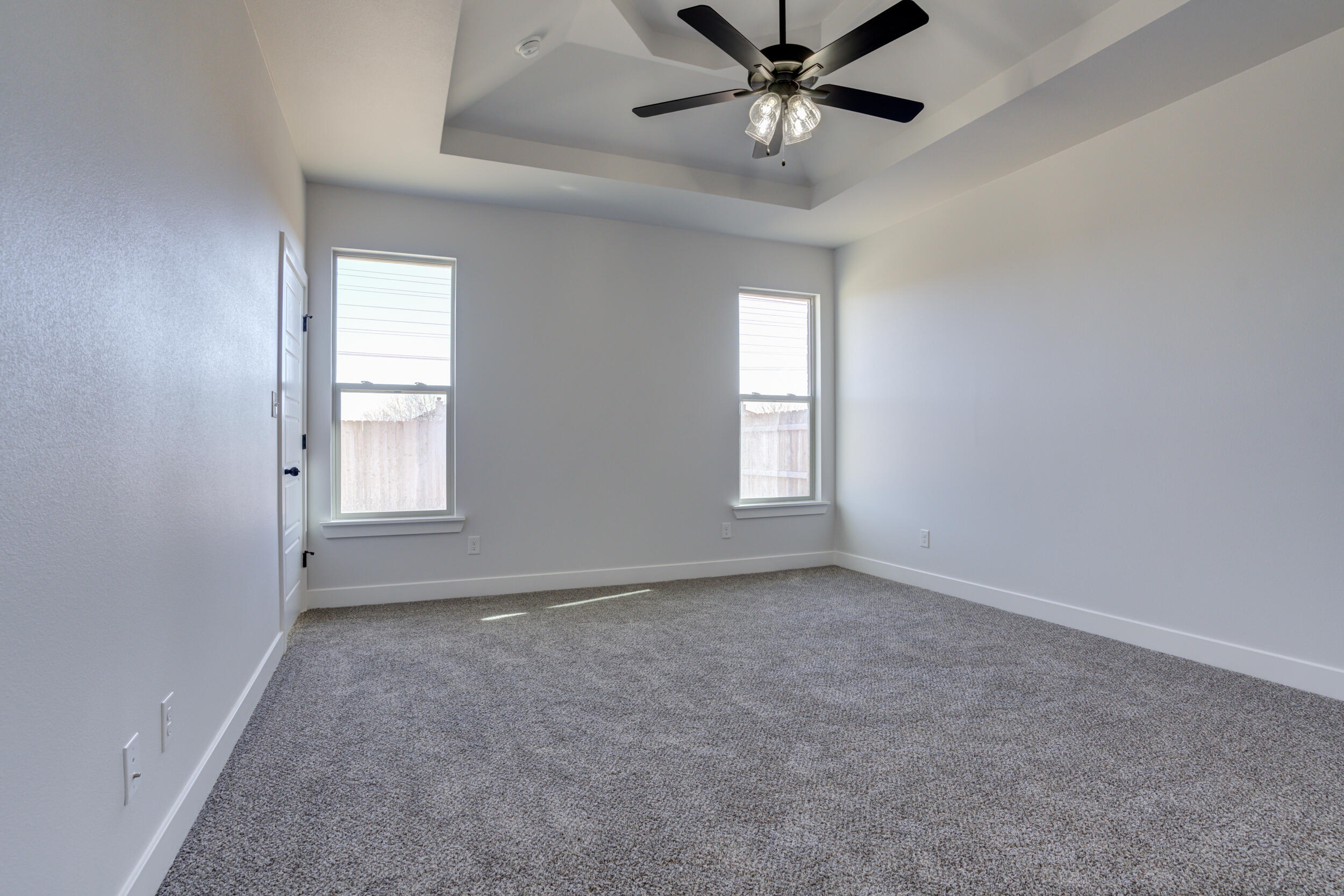 1005 Quincy Avenue Lubbock, TX 79416 - Photo 35 of 46 an empty room with windows and fan