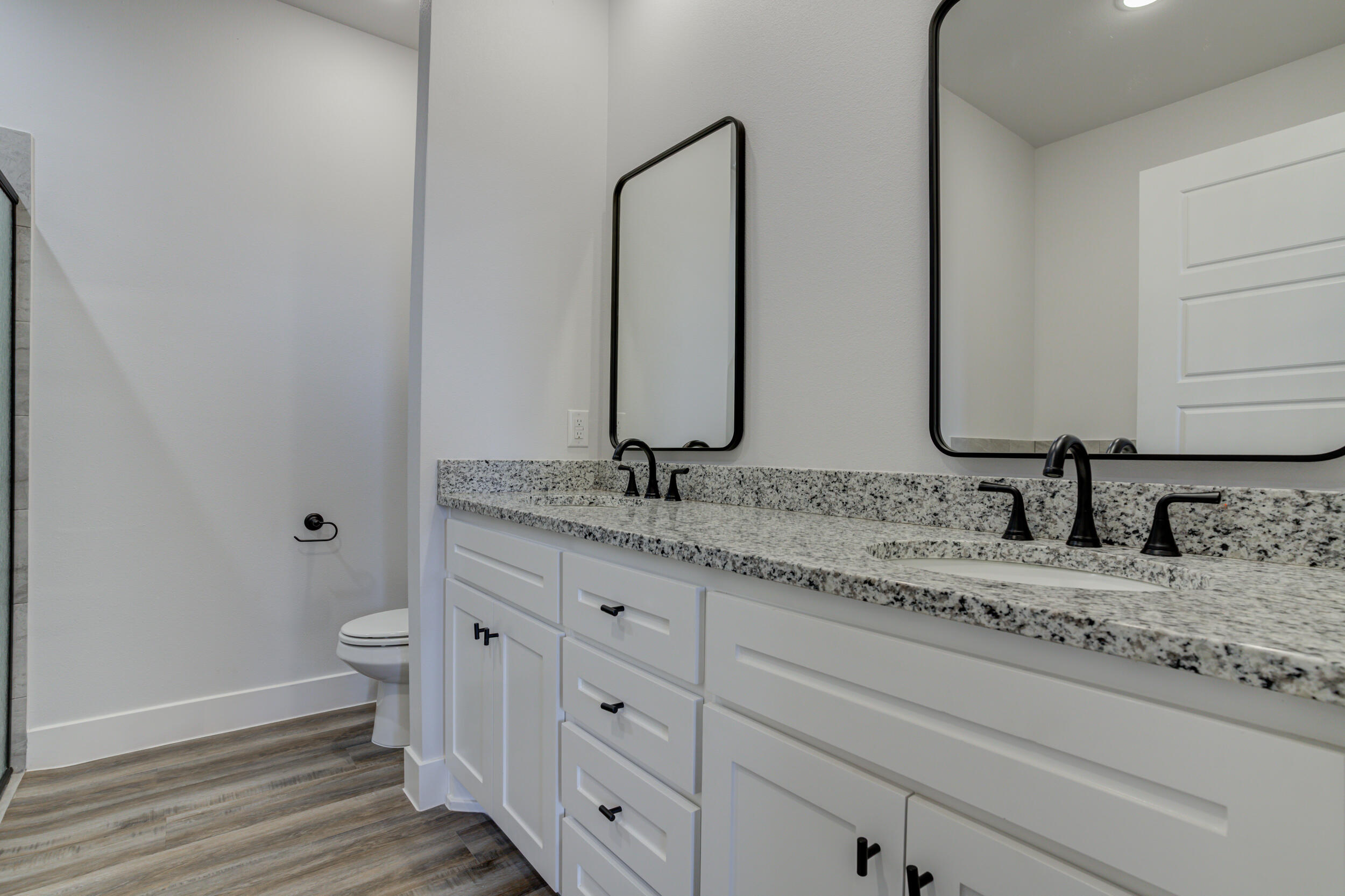 1005 Quincy Avenue Lubbock, TX 79416 - Photo 38 of 46 a bathroom with a granite countertop sink and a mirror