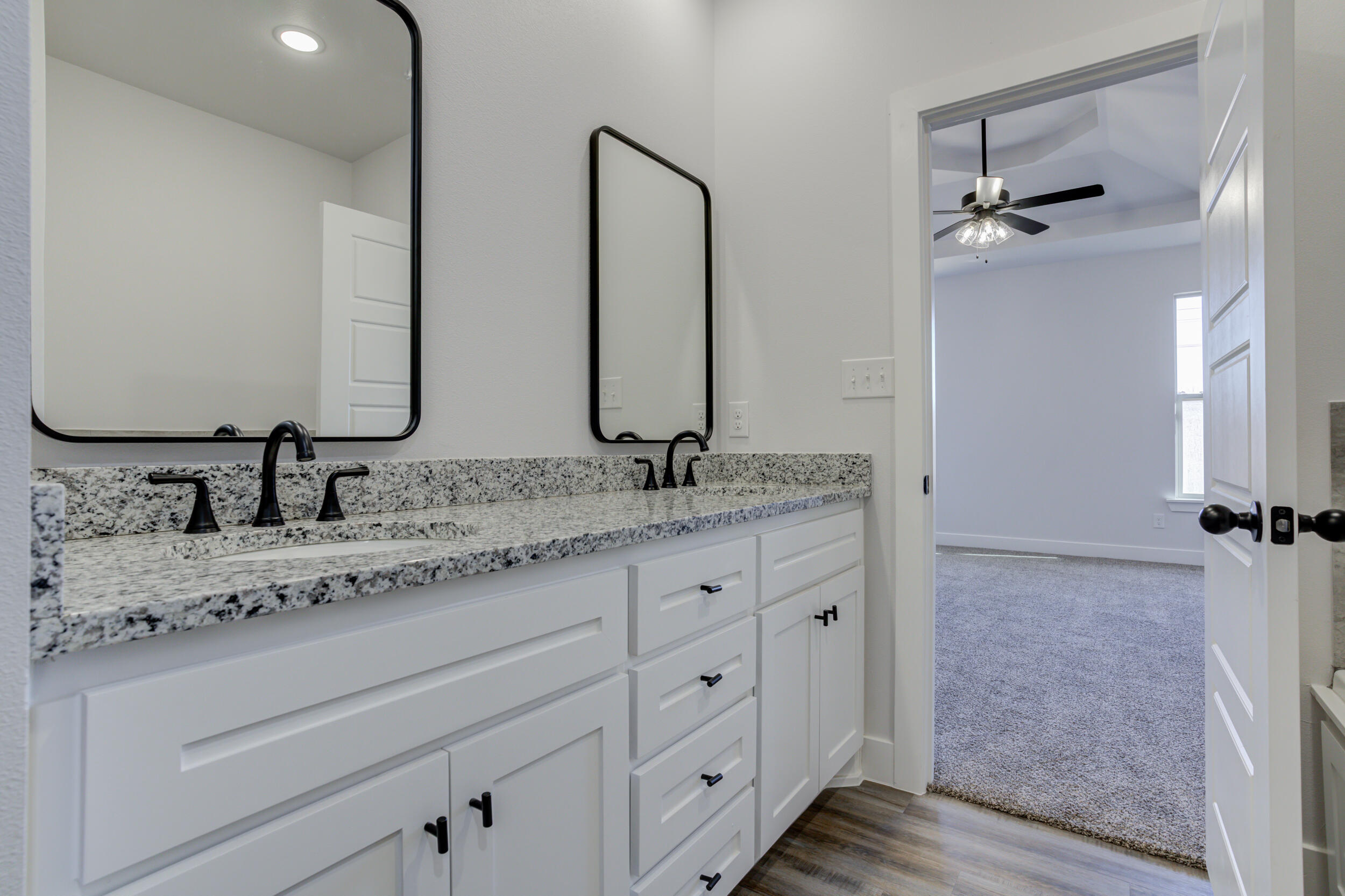 1005 Quincy Avenue Lubbock, TX 79416 - Photo 40 of 46 a bathroom with a granite countertop sink and a mirror