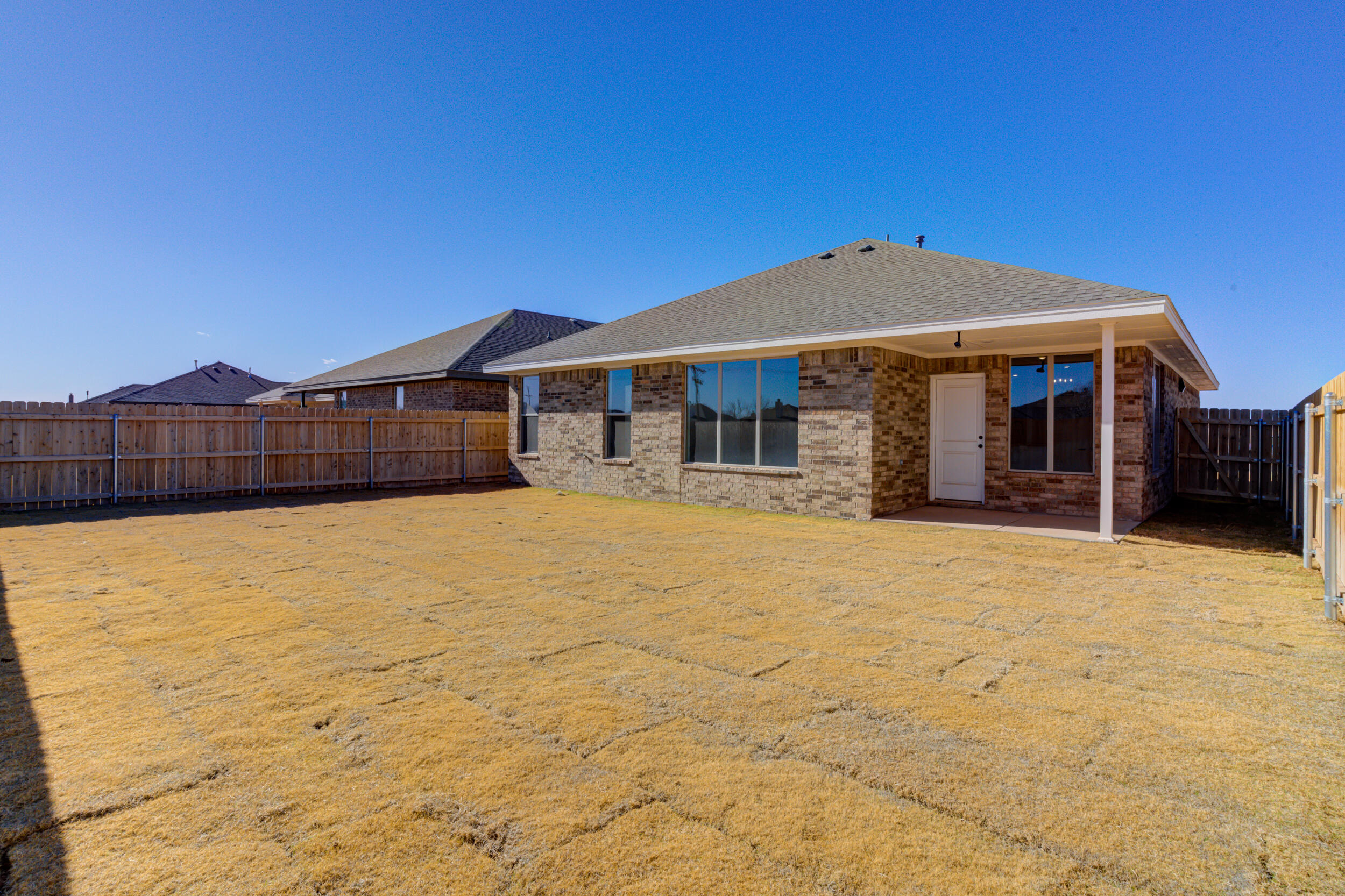 1005 Quincy Avenue Lubbock, TX 79416 - Photo 45 of 46 a front view of a house with a yard