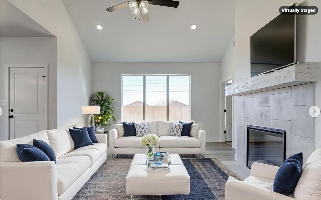 1005 Quincy Avenue Lubbock, TX 79416 - Photo 5 of 46 a living room with furniture a flat screen tv and a fireplace
