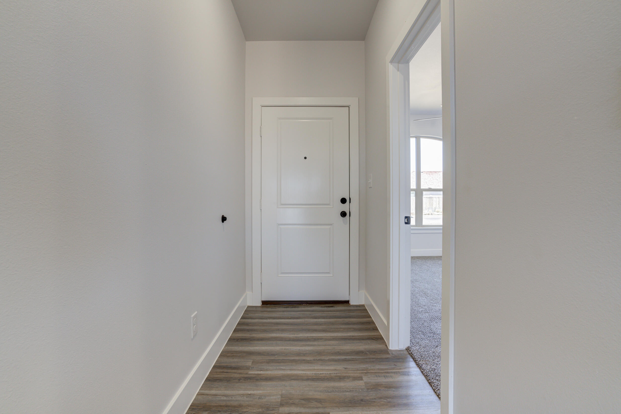1005 Quincy Avenue Lubbock, TX 79416 - Photo 7 of 46 a view of a hallway with wooden floor