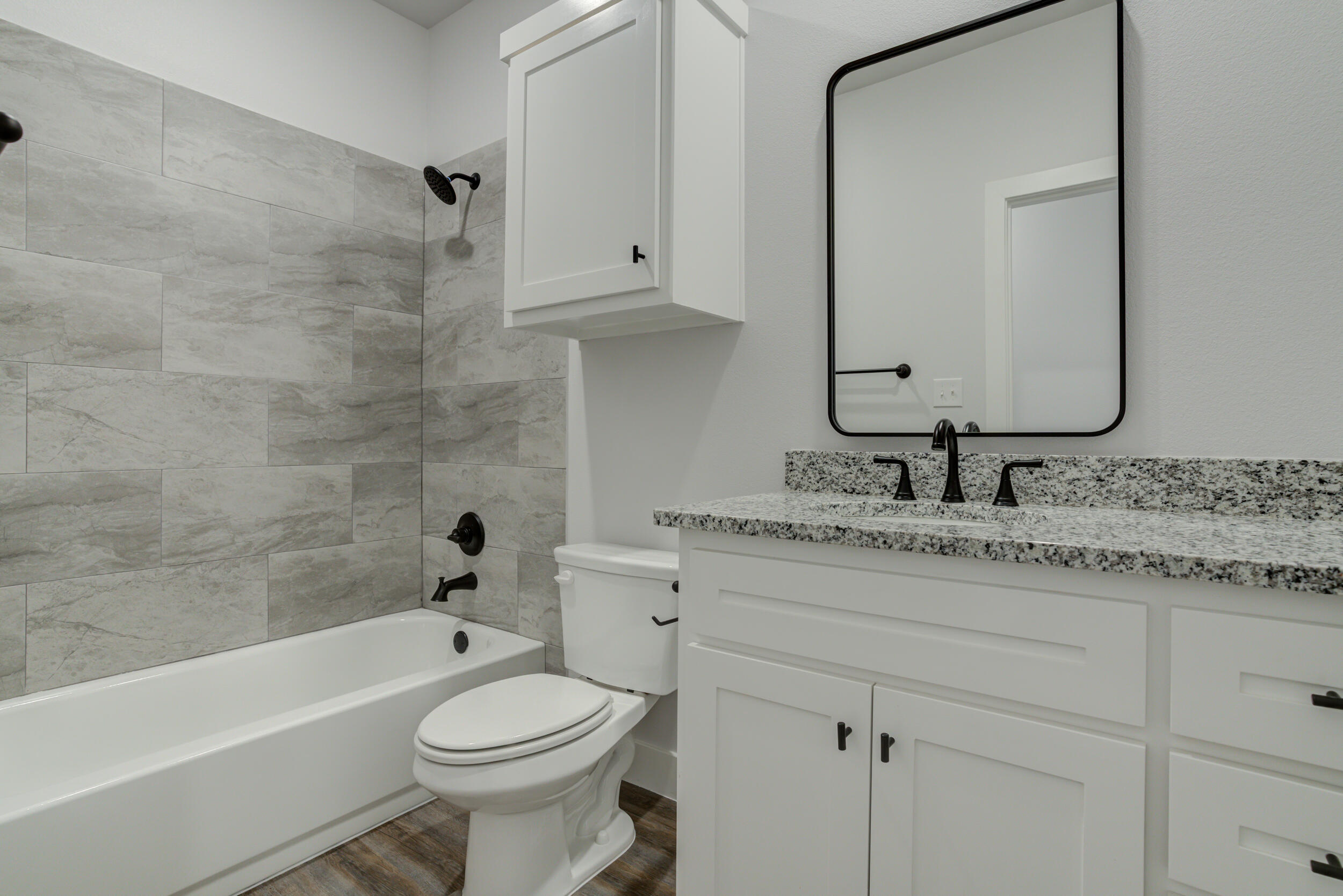 1005 Quincy Avenue Lubbock, TX 79416 - Photo 10 of 46 a bathroom with a granite countertop toilet sink and mirror