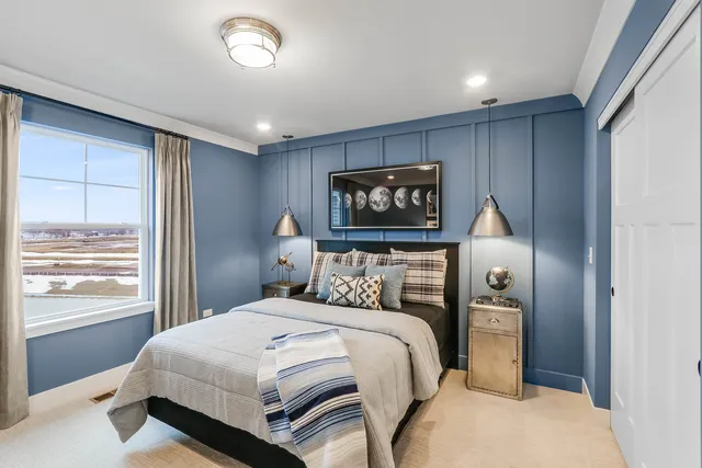 a bedroom with a large bed and a window