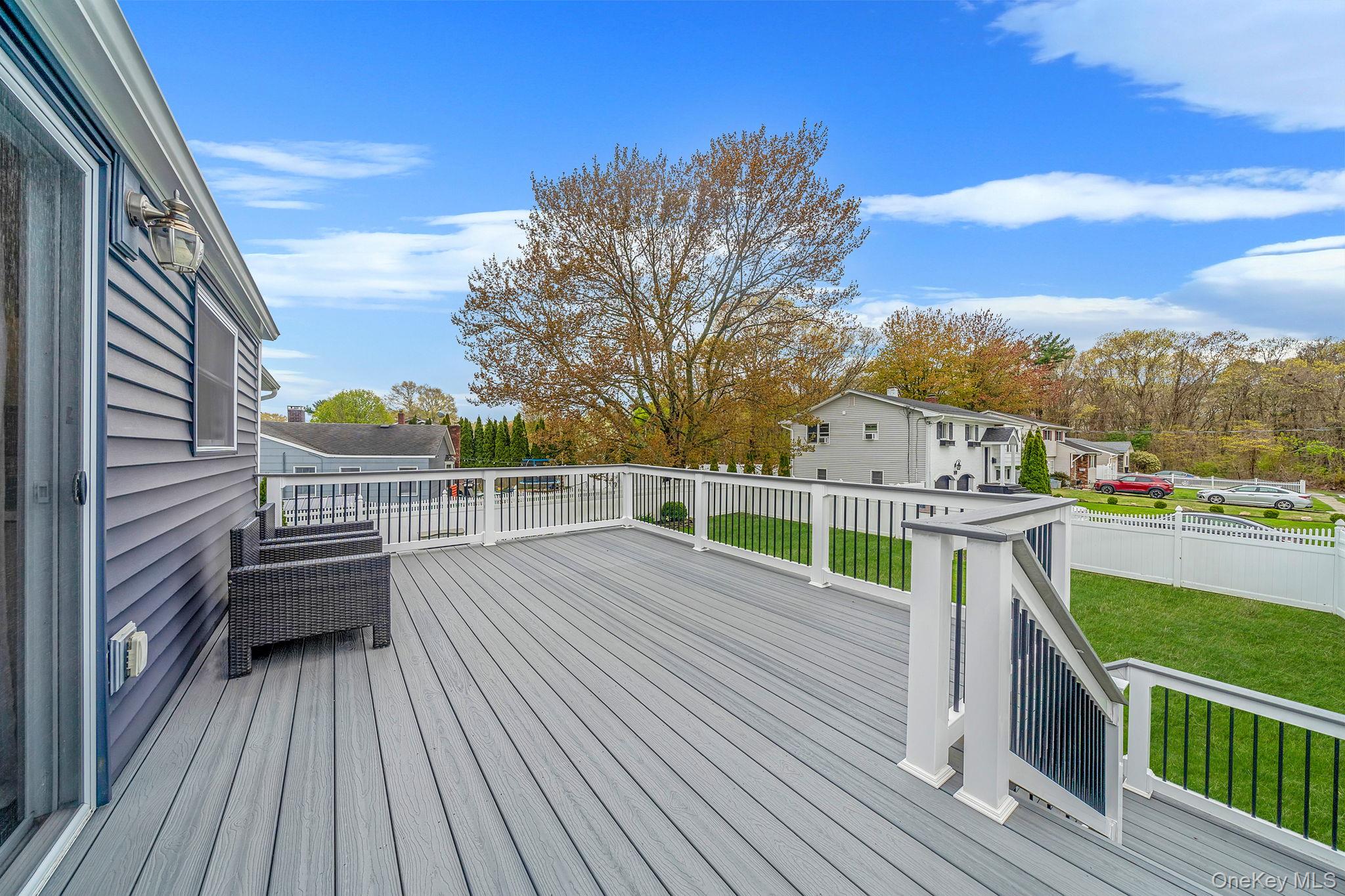 110 Stephen Road Bayport, NY 11705 - Photo 11 of 39 a view of a balcony with wooden floor and fence