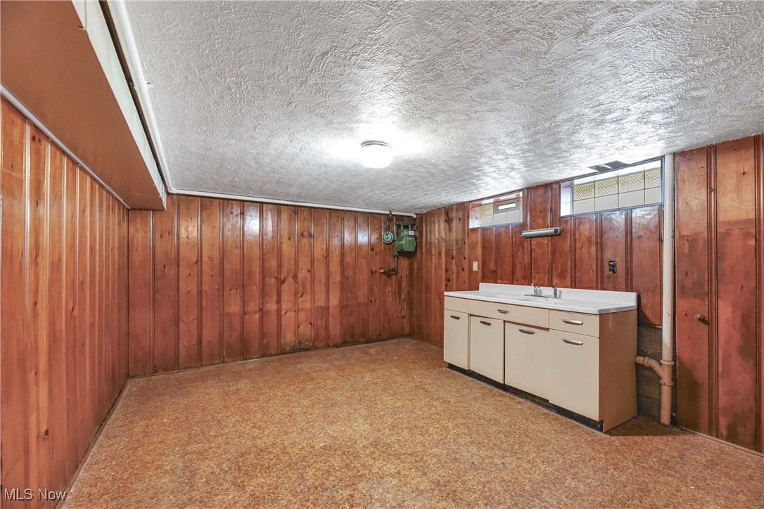 6506 Snow Road Parma, OH 44129 - Photo 22 of 25 Wooden walls, light countertops, and a textured ceiling