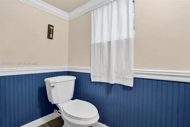 a bathroom with a toilet a sink and a window