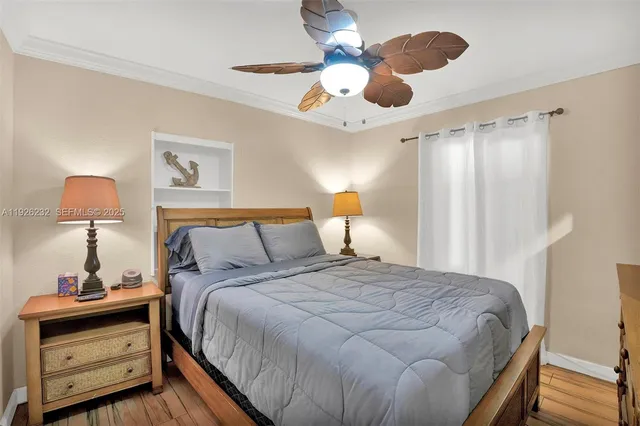 a bedroom with a bed and a lamp on the dresser